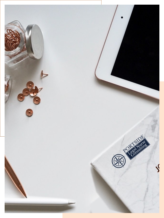 A tablet, notebook, pen, jar of copper push pins, and scattered push pins are arranged on a white desk.